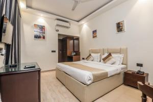 Ένα ή περισσότερα κρεβάτια σε δωμάτιο στο The Orion Express - Kailash Colony +97 φωτογραφίες