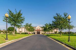 a driveway leading to a large house at Quality Suites Graham - Burlington South in Graham
