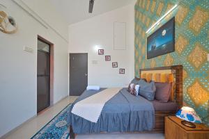 a bedroom with a bed and a wall at ll EMPYREAN STAY ll 2BHK ll LUCIFER VILLA ll AC ll PRIVATE POOL ll in Lonavala