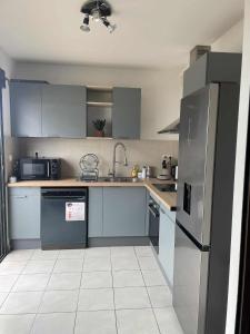 a kitchen with a stainless steel refrigerator and appliances at Evasion du Lagon in Saint-Pierre