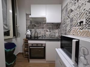 a small kitchen with a stove and a sink at Maison Luisa in Pozzuoli