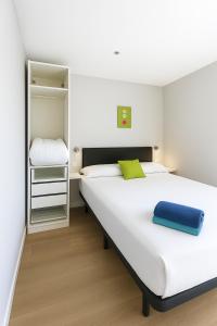 a bedroom with a large white bed and a closet at Nuñez de Arce in Toledo