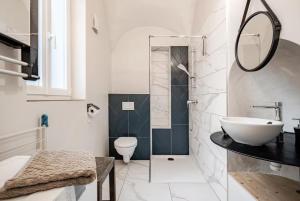 a white bathroom with a sink and a toilet at Maison des Moines Terrasse & Confort in Valence +9 photos