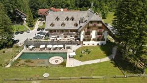 an aerial view of a large house with a swimming pool at Villa Palenk Logar Valley in Solčava