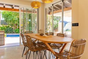 カーラ・デ・フィネストラットにあるExclusive house in Finestratの木製のテーブルと椅子のあるダイニングルーム