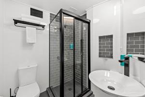 ブリスベンにあるMadison Tower Mill Hotelのシャワー、トイレ、洗面台を備えたバスルーム