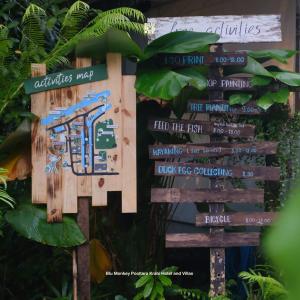 a sign with many different signs on it at Blu Monkey Pooltara Krabi Hotel & Villas Pet Friendly in Tha Lane Bay