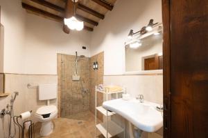 a bathroom with a sink and a toilet and a mirror at Agriturismo La Palazzetta di Assisi in Assisi +31 photos