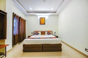 a bedroom with a large bed in a room at Hotel Alaknanda Paradise in Dehradun