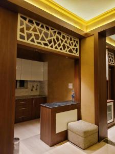 a kitchen with a counter in the middle of a room at Hotlel Sanjivani Salasar in Juliāsar