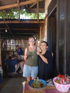 a man and a woman standing next to a table at Bale Rinjani Bungalows in Tetebatu