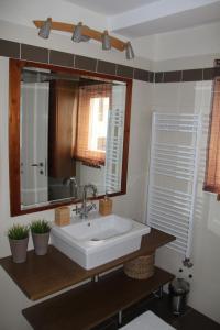 a bathroom with a white sink and a mirror at Queen Zita Apt 130 m2 near Chain Bridge in Budapest