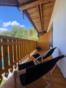 a balcony with two chairs and a wooden ceiling at Michałówka na Kubalowej Łące in Szczyrk +66 photos