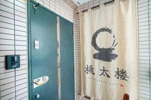 una doccia con una tenda da doccia con un simbolo giapponese di Momotarou Stay a Yokohama Altre 65 foto