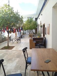 a patio with a wooden table and chairs at Derin park otel in Sanlıurfa