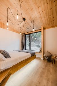 a bedroom with a bed in a room with wooden ceilings at River Escape Retreat & Spa - Adults Only in Avrig +43 photos