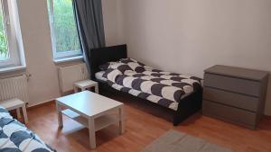 a living room with a couch and a table at Crew Quartier ALL-INCLUSIVE Serviced Apartment in Krostitz in Krostitz
