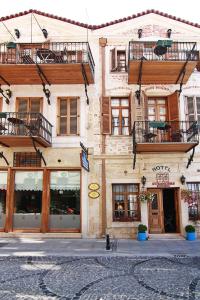 a building with windows and balconies on a city street at Hotel Des Etrangers - Special Category in Çanakkale