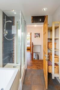 a bathroom with a shower and a bath tub at Pass the Keys 3-Bedroom Home in Chelmsford Sleeps 7 in Great Baddow