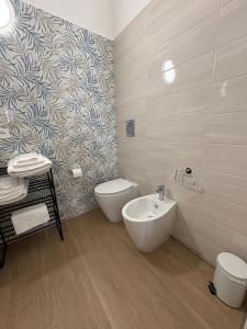 a bathroom with a toilet and a bidet and a sink at Dreams29 in Cosenza +25 photos