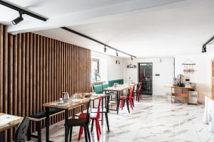 a restaurant with long tables and red chairs at Willa Józef in Zakopane