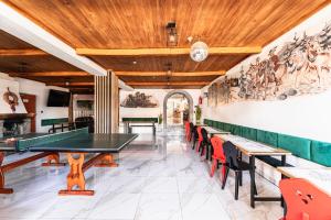 a dining room with a ping pong table and chairs at Willa Józef in Zakopane