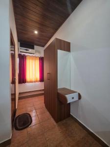 a bathroom with a sink on a wall at Hotel Prithesh Tourist Home in Bantvāl