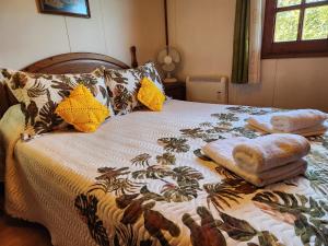 a bed with a blanket and pillows on it at Rincón de Madagascar VV-2192-AS in Arriondas