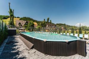a large swimming pool with a fence around it at Willa Józef in Zakopane