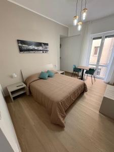 a bedroom with a large bed and a table and chairs at Dreams29 in Cosenza