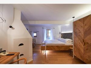 a bedroom with a bed and a desk in a room at Villa Palenk Logar Valley in Solčava +32 photos