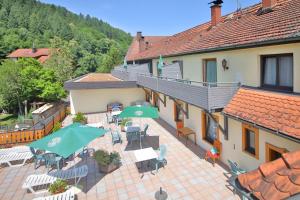 an external view of a building with tables and umbrellas at Hotel Restaurant Freihof in Oberharmersbach