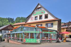 a large building with a restaurant in front of it at Hotel Restaurant Freihof in Oberharmersbach