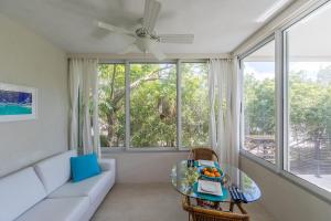 a living room with a couch and a table at Wyakha 1 Garden View in Long Bay Hills