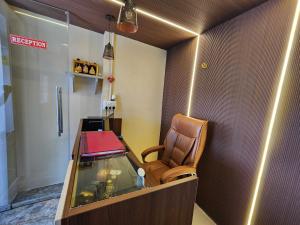 a waiting room with a chair and a fish tank at Hotel O SSR residency in Chennai