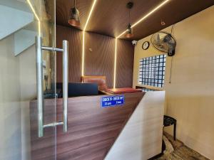 a lobby with a counter with a blue sign on it at Hotel O SSR residency in Chennai