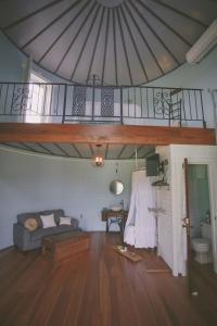 a living room with a couch and a staircase at Converted Grain Silo for Unique Glamping Accommodation in Alvin, Illinois in Alvin