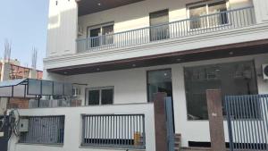 a white building with windows and a balcony at Hotel O Lavish Hotel in Greater Noida
