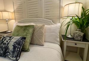 En eller flere senge i et værelse på Jacaranda House Garden Suite