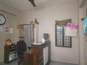 an office with a desk and a chair and a window at HOTEL O THE HOTEL TRIYA in Warangal