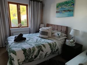 a bedroom with a bed and a window at Room with rural views in Ferns