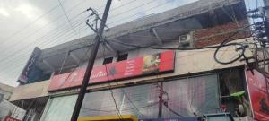 a building with a sign on the side of it at HOTEL O THE HOTEL TRIYA in Warangal +2 photos