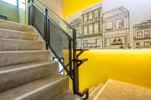 a staircase with a mural of a building at Patong Poshtel in Patong Beach