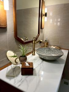 a bathroom counter with a sink and a mirror at Lost Horizon Resort - Khao Sok in Khao Sok National Park