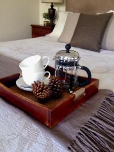 a tray with a tea set on a bed at Jacaranda House Garden Suite in Brisbane +39 photos