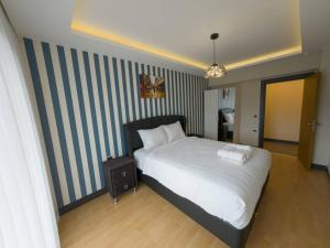 Ένα ή περισσότερα κρεβάτια σε δωμάτιο στο Utopia Suite Residence1
