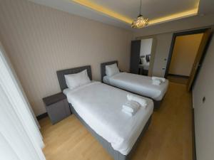 Ένα ή περισσότερα κρεβάτια σε δωμάτιο στο Utopia Suite Residence1