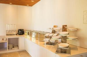 a kitchen with a counter with white bowls and sinks at Paradise Found in Dhigurah
