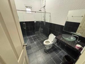 a bathroom with a toilet and a sink and a shower at Gmob Pool Villa Resort in Ban Map Fakthong +4 photos