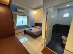 a small bedroom with a bed and a bathroom at Gmob Pool Villa Resort in Ban Map Fakthong